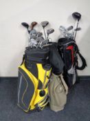 Four golf bags containing assorted irons,