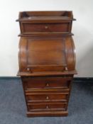 A Victorian style cylinder bureau fitted four drawers