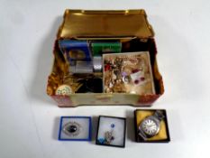 A tin containing coins, bracelet,