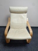 An Ikea wood framed armchair with cream leather cushion