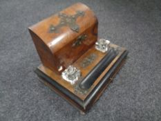 An Edwardian walnut and brass desk stand with glass inkwells