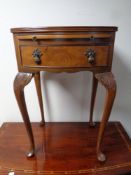 A walnut side table fitted a drawer and slide