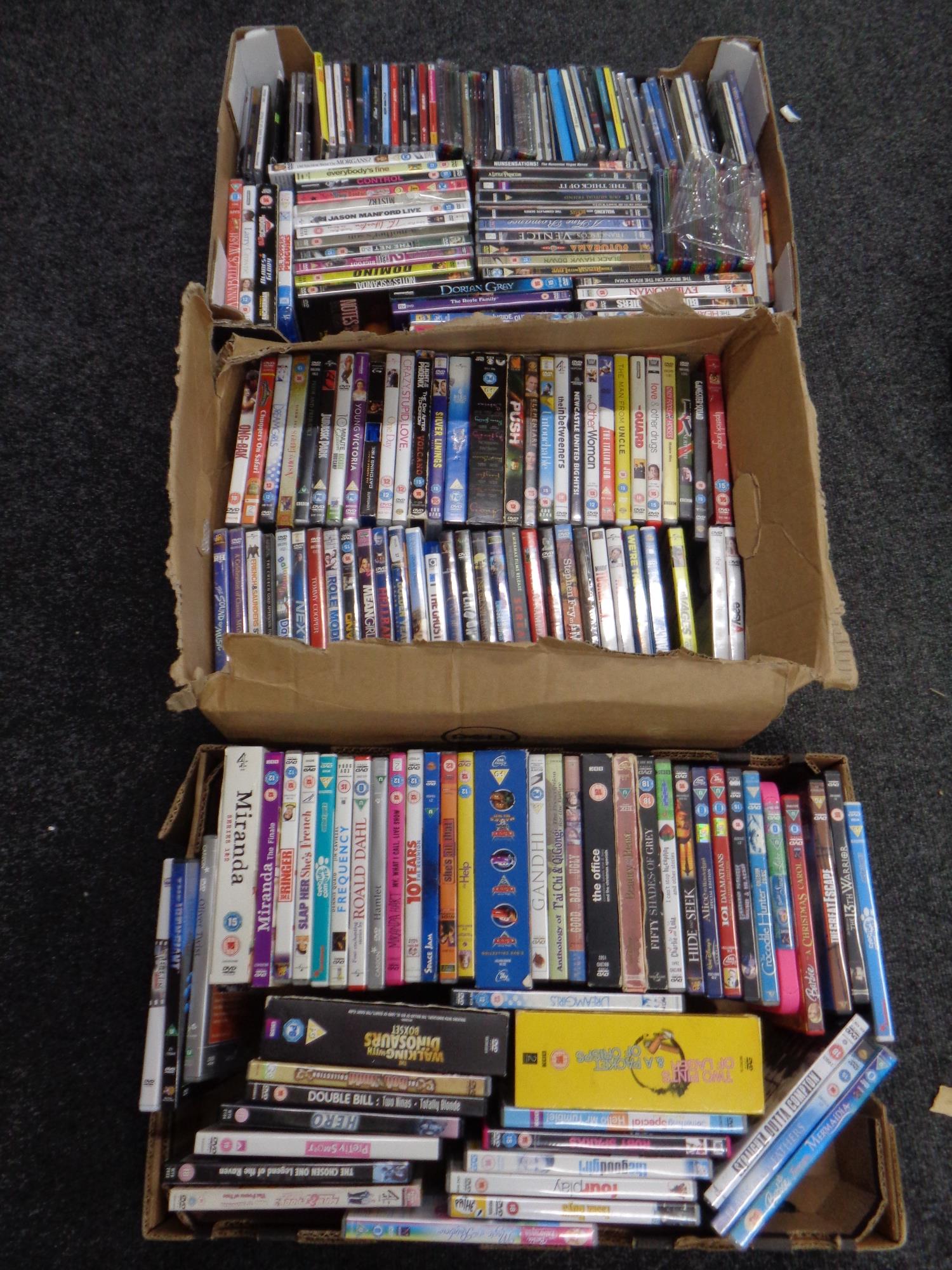 Four boxes containing various DVDs to include children's