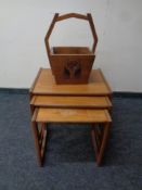 A nest of three 20th century teak G Plan tables together with a wooden caddy