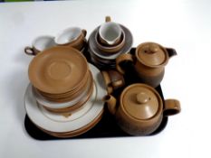 A tray of thirty four pieces of Denby Cotswold tea and dinner ware