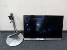 A Bang and Olufsen Beo Vision 7 TV together with a Beo Vision 4 remote and motorised stand