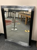 A contemporary black framed mirror,