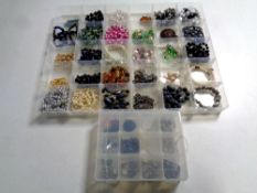 Three plastic comportment trays containing costume jewellery including necklaces, bracelets,