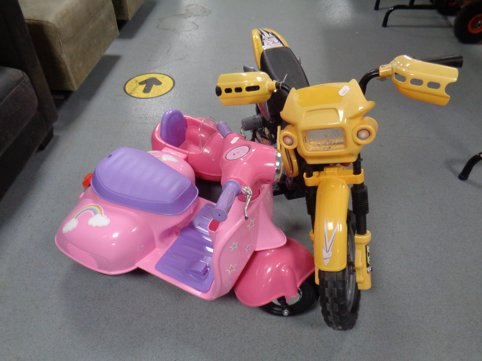 A ride on electric motocross bike with stabilisers together with a ride on scooter with doll