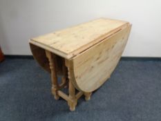 A heavy pine stripped drop leaf table