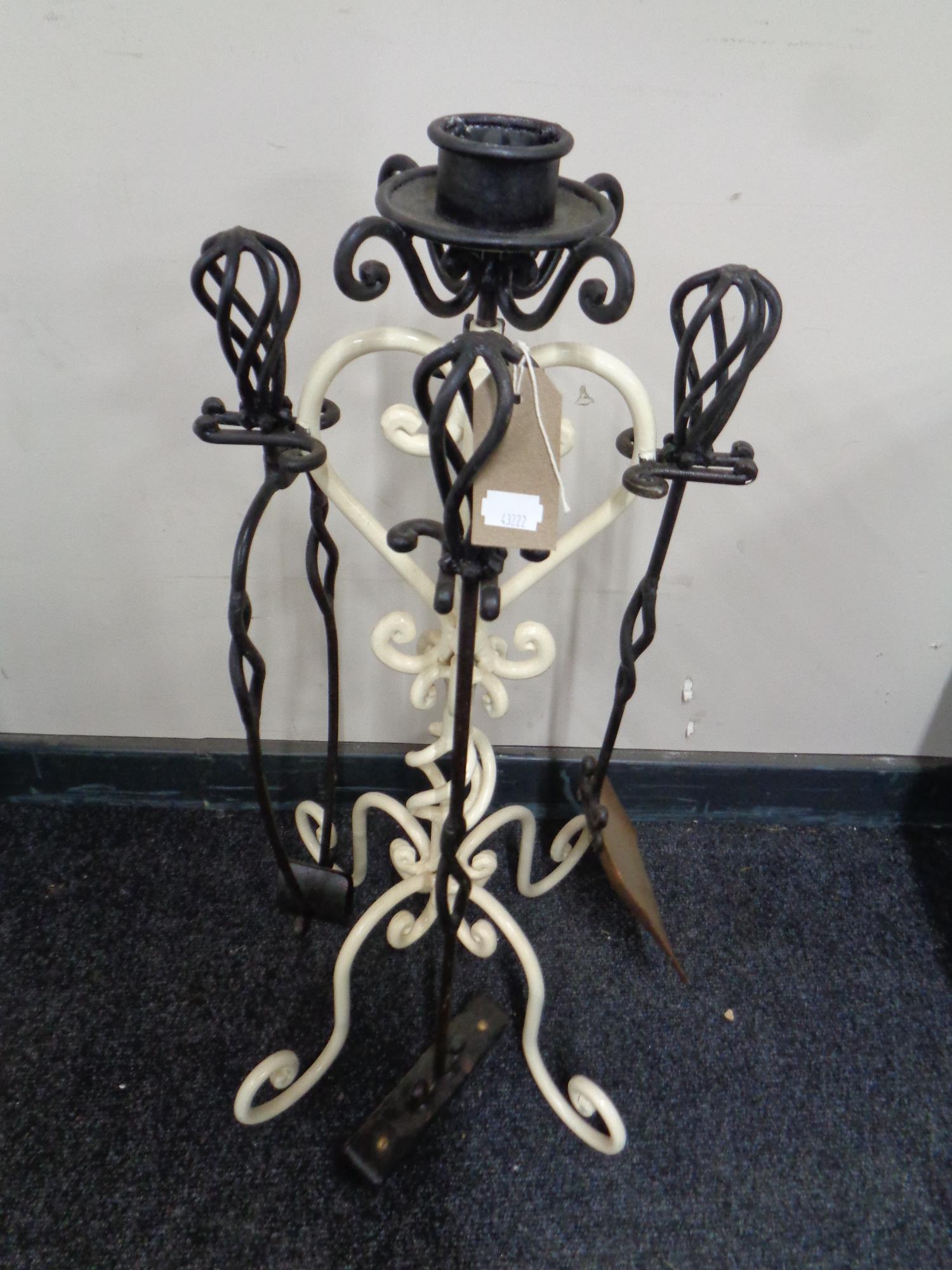 A four piece cast iron companion set on stand