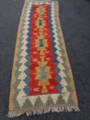 A fringed Kilim carpet runner