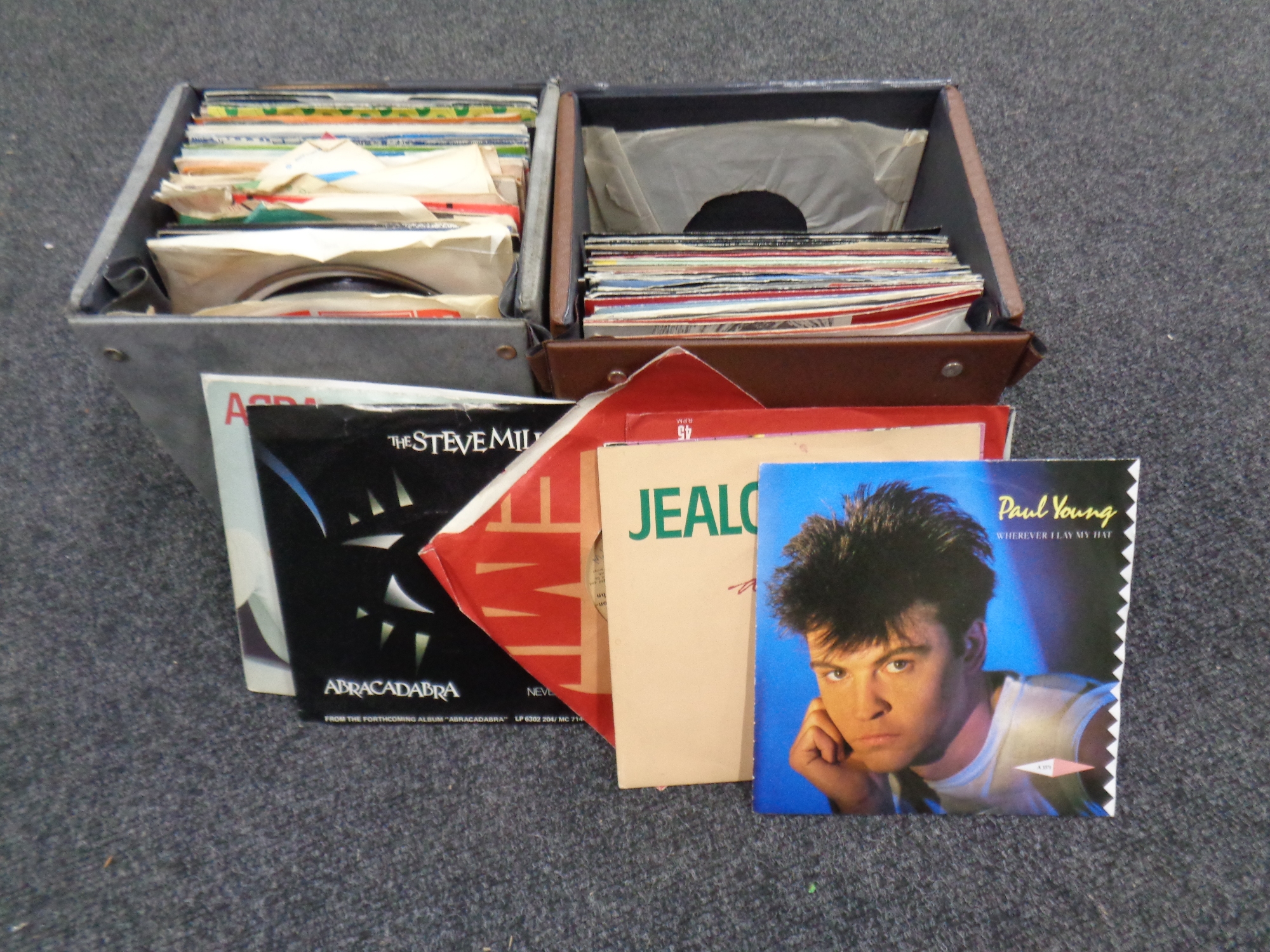 Two cases containing vinyl seven inch singles to include Diana Ross, Brotherhood of Man,