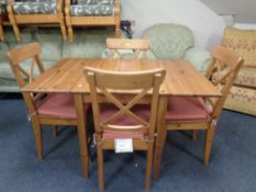 An Ikea pine drop leaf kitchen table together with four chairs