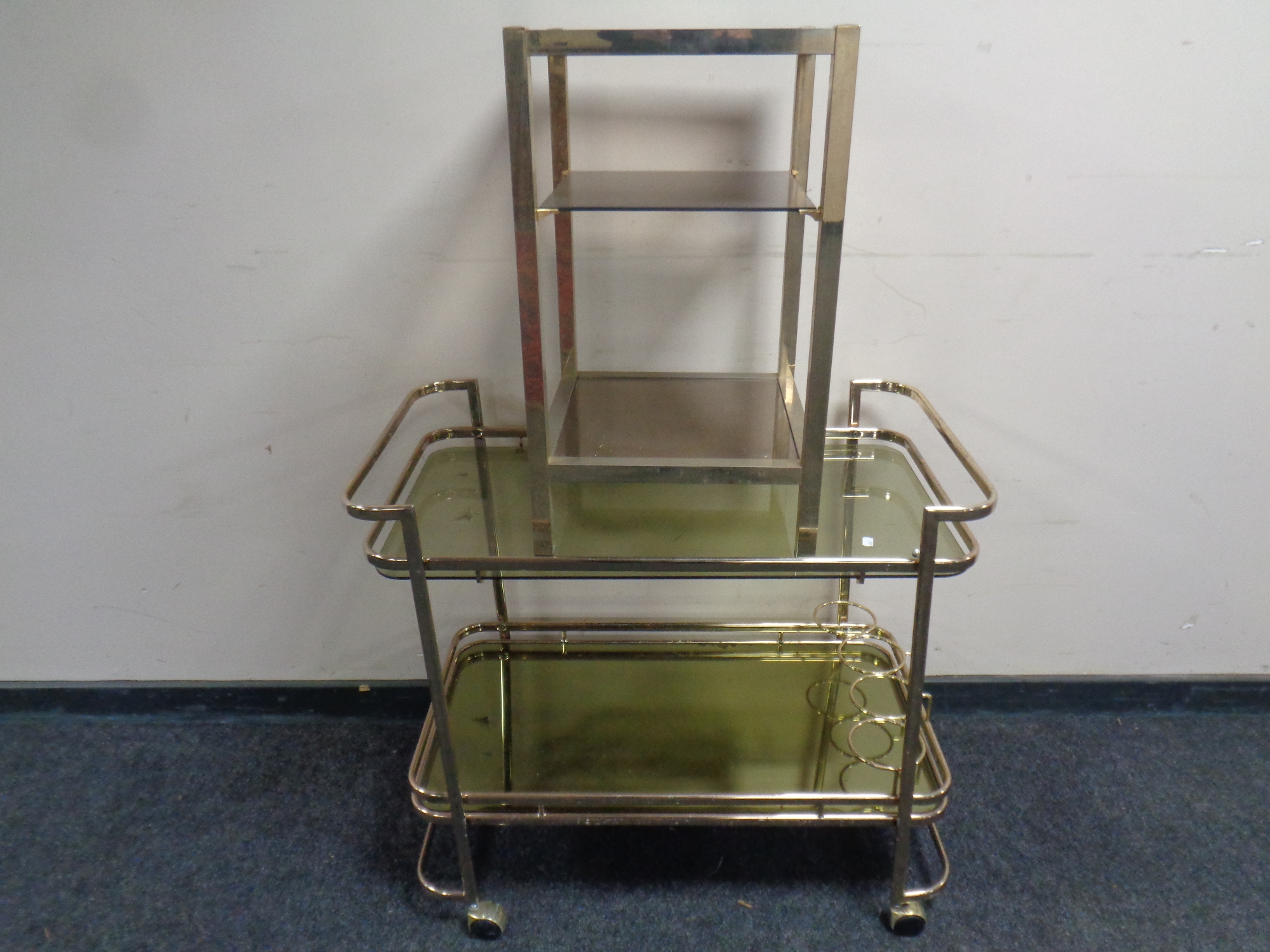 A 20th century glass and metal two tier drinks trolley together with a further glass and metal