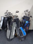 Four golf bags containing assorted irons,