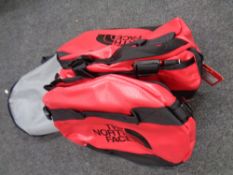 A North Face base camp duffel bag, large (red) in a mesh carry bag,