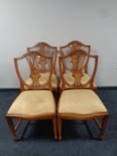 A set of four yew wood shield back dining chairs