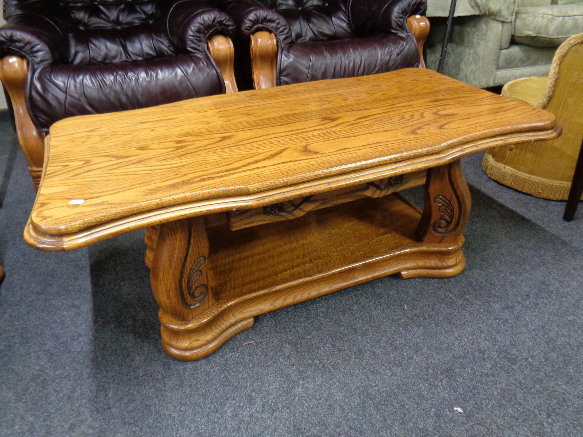 A contemporary oak two tier shaped coffee table