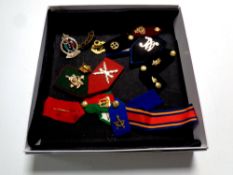 A box of military epaulets with badges, assorted coins,