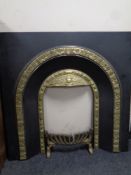 A cast iron and brass Victorian style fire insert