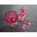 A 19th century cranberry glass vase and a cranberry glass jug,