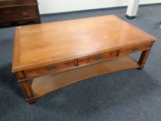 An oversized rectangular two tier coffee table fitted drawers in a mahogany finish