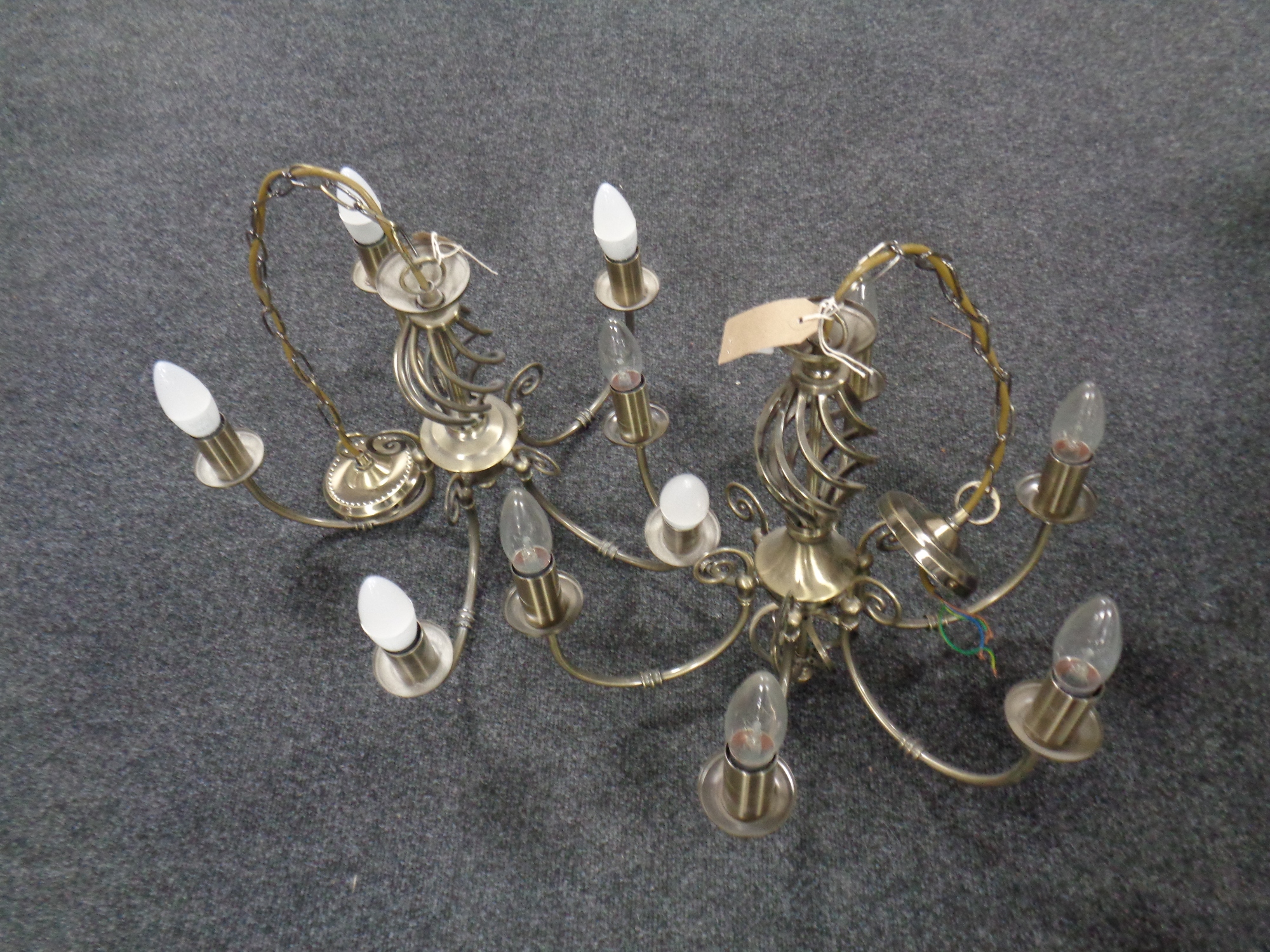 A pair of contemporary six branch light fittings in an antique brass finish