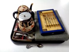 A tray containing boxed and unboxed cutlery, silver teaspoon,