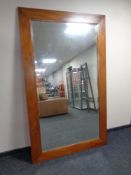 A contemporary eastern teak framed bevel edged mirror,