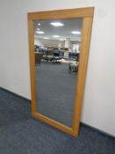 A contemporary oak framed overmantel mirror