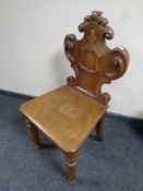 An Edwardian carved oak hall chair