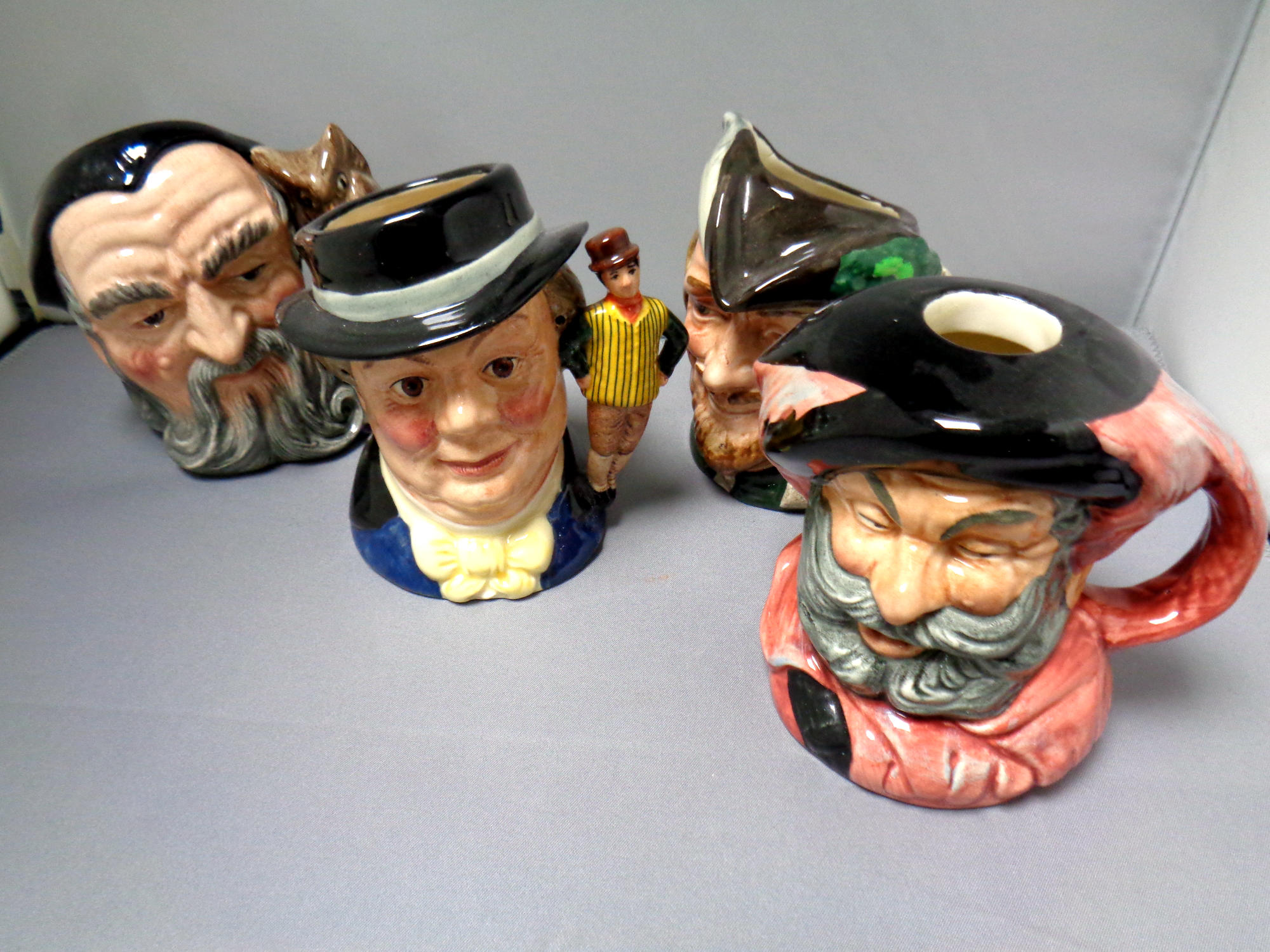 Four small Royal Doulton character jugs : Falstaff, Robin Hood,