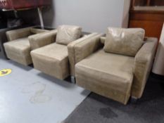 Three contemporary leather armchairs on chrome feet,