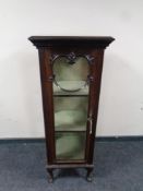 An Edwardian display cabinet on raised legs