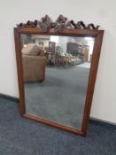 A 19th century mahogany framed mirror surmounted with carved bow decoration