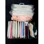 A box of assorted bedding (sealed), table linen,