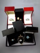 A box of silver gilt jewellery including six dress rings and a pair of cameo earrings