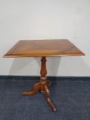 A 19th century oak pedestal occasional table with parquetry top