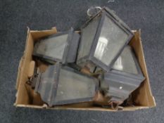 A box containing four cast iron lantern outdoor lights