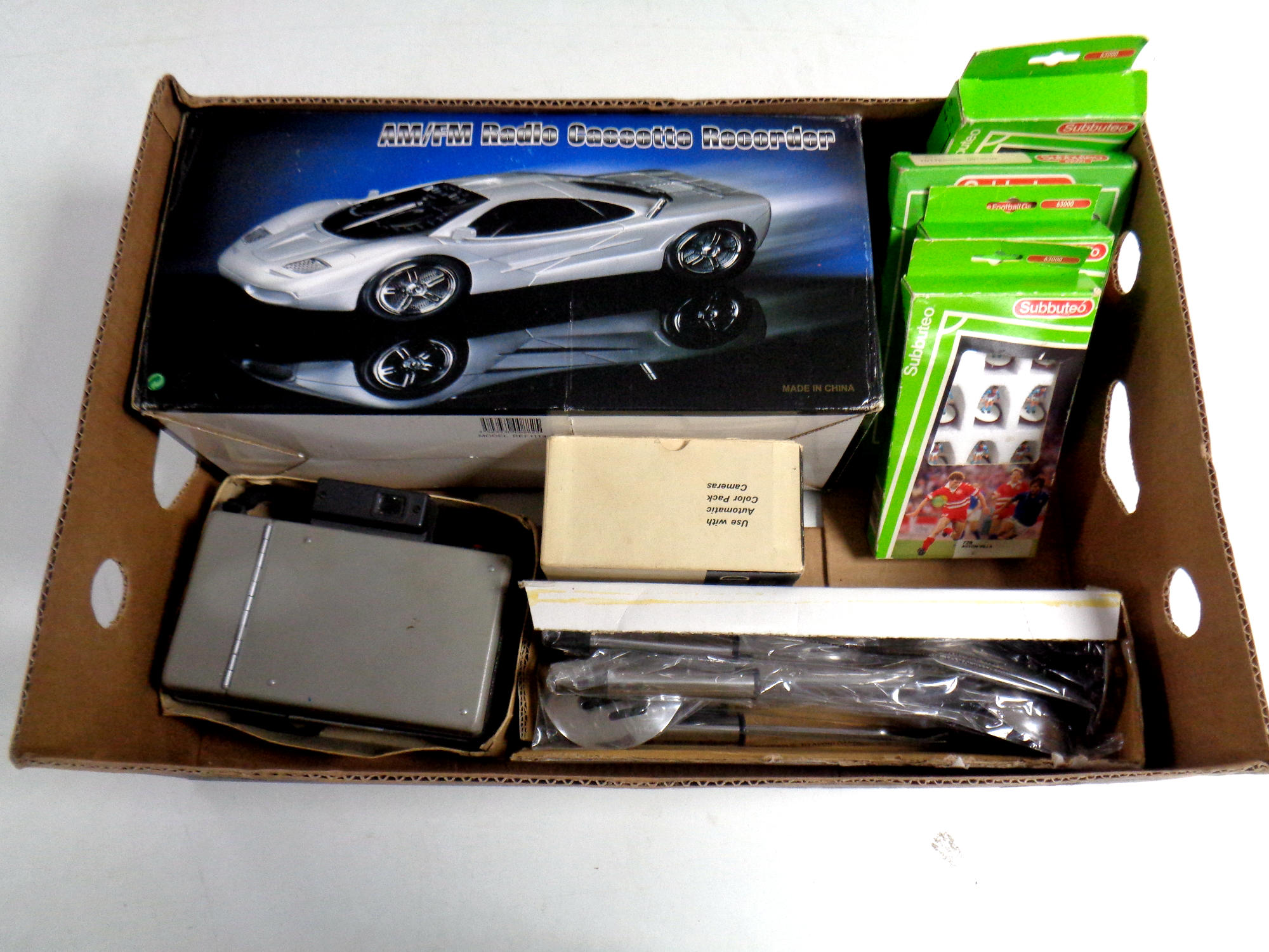 A box of Subbuteo teams, kitchen utensils, Polaroid camera & flash gun,