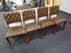 A set of four Chesterfield style buttoned leather dining chairs
