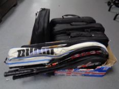 A box containing five laptop bags together with assorted sports rackets