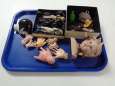 A tray containing antique and later porcelain plastic and glass dolls,