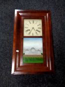 A 19th century mahogany cased Chauncey Jerome American wall clock with pendulum and weights