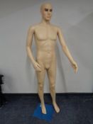 A male shop mannequin on stand