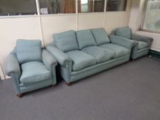 A three piece Victorian style lounge suite upholstered in a turquoise fabric