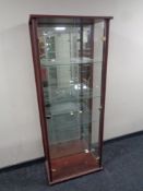 A contemporary double door display cabinet in a mahogany finish
