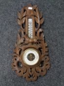A carved Black Forest style barometer