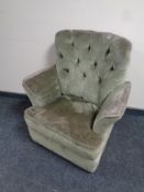 A 20th century armchair upholstered in a green button dralon